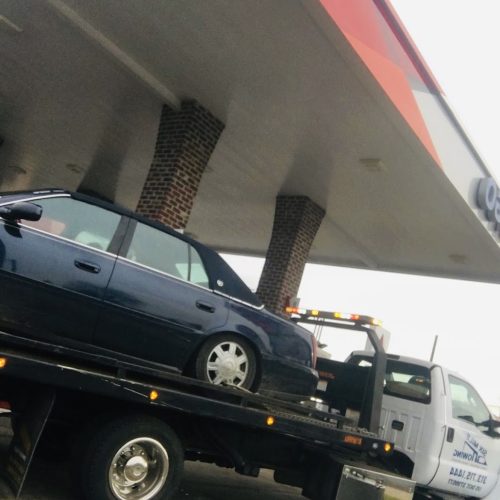 car on the back of a tow truck