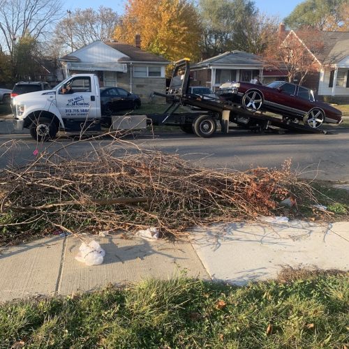 car on the back of a Six Mile Towing tow truck